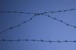 Barbed wire against a blue sky