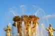 Golden fountain on blue sky
