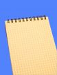 yellow notebook over blue background