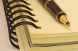 yellow notebook and pen