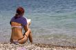 beautiful girl reading a book at the beach