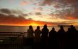 Cruise ship passengers taking pictures of sunset