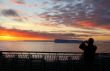 Cruise ship passengers taking pictures of sunset