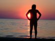 A black silhouette of a young guy on a sunset 1