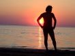 A black silhouette of a young guy on a sunset 2