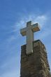 stone cross over blue sky