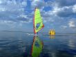 Windsurfer and its reflection in water of a gulf