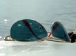 The sunglasses laying on a white surface