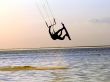 Silhouette of a kitesurf, a flying above water