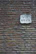 ancient roman wall with street nameboard