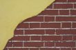 red brick wall with yellow stucco