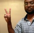 african american man gesturing a peace sign