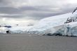 Overcast, glaciers falling into the sea