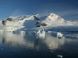Glaciated mountain, reflected in ocean mirror,