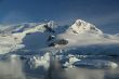 Glaciated mountain, reflected in ocean mirror,