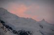 Subtle alpenglow lights snowy mountain