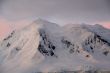 Subtle alpenglow lights snowy mountain
