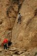 Woman belaying a climber on rock face
