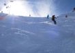 Backlit skiers in powder snow