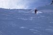 Red skier in powder snow