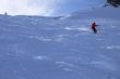Red skier in powder snow
