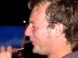 The guy smokes a hookah and smiles