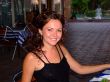 The smiling girl sits at restaurant