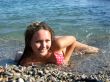 The sexual girl lays on a pebble on seacoast2