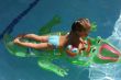 Girl swimming on crocodile