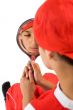 young boy holding a mirror
