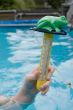 hand is holding a water temperature