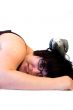 woman laying with grey parrot on her head