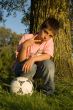 boy showing peacesign and holding soccer