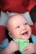 Baby sitting in stroller. First teeth