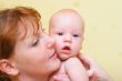 Mother gently holding baby in hands