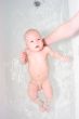 Mother wash baby in bath