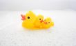 Three rubber ducks in foam water #4