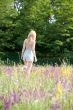 Girl in underwear going away on meadow