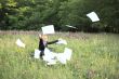 Businesswoman on nature with laptop catch documents #2