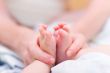 Mother gently hold baby leg in hand #5