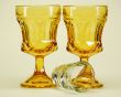 yellow stemmed drinking glasses and shot glass