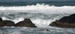 Waves breaking on volcanic rock