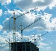 construction cranes over blue sky background