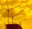 construction cranes in sunset lights