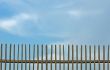 blue sky over old fence