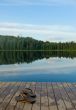 pair of slippers on a pier of the lake