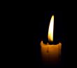 candle flame over black background with copyspace
