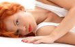 laying redhead in white shirt