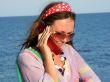 The beautiful girl talks by a mobile phone