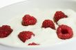Yogurt and raspberries in a bowl.